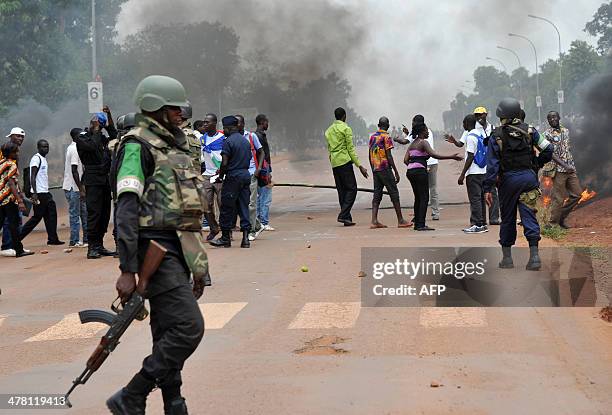 Congolese soldiers from Misca , Centrafrican Gendarmerie and police members patrol on March 12, 2014 in Bangui as students demonstrate to ask for the...