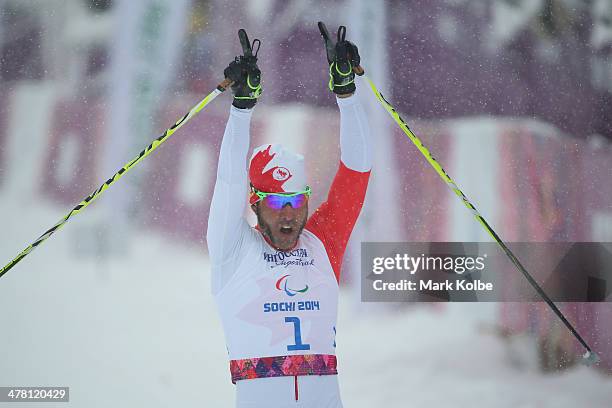 Brian McKeever of Canada celebrates winning gold in the men's 1km sprint, visually impaired cross-country during day five of Sochi 2014 Paralympic...