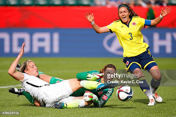 Abby Wambach of the United States kicks the ball away from goalkeeper Catalina Perez of Colombia but Wambach is called for offsides in the first half...