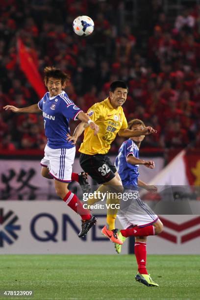 Sun Xiang of Guangzhou Evergrande and Shingo Hyodo of Yokohama F. Marinos battle for the ball during the AFC Asian Champions League match between...