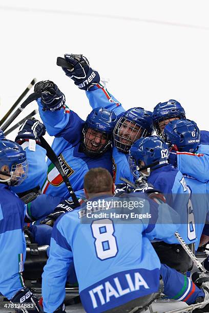 Giuseppe Condello and Andrea Macri of Italy celebrate victory during the Ice Sledge Hockey Classification match between Italy and Sweden at the...