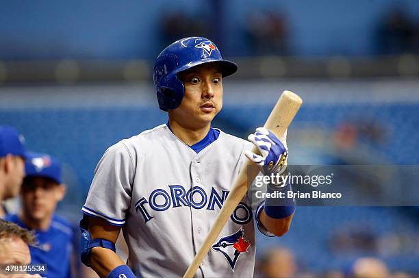 Munenori Kawasaki of the Toronto Blue Jays looks down at his bat as he makes his way out to the bat at the start of the third inning of a game...