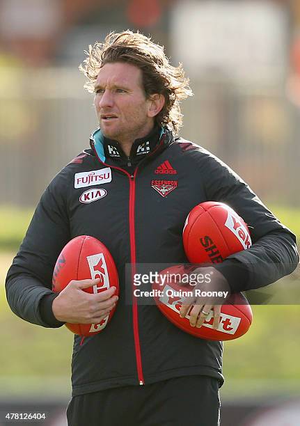 James Hird the coach of the Bombers watches on during an Essendon Bombers AFL training session at True Value Solar Centre on June 23, 2015 in...