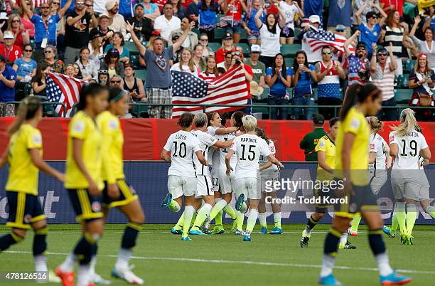 Alex Morgan of the United States celebrates with teammates after Morgan scores her first goal against goalkeeper Stefany Castano of Colombia in the...