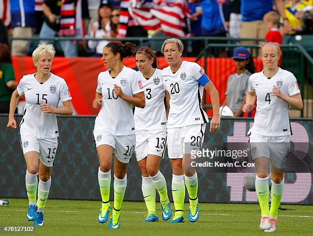 Alex Morgan and Abby Wambach of the United States celebrate after Morgan scores her first goal against goalkeeper Stefany Castano of Colombia in the...