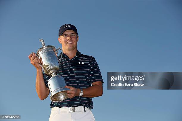 Jordan Spieth of the United States poses with the trophy for photographers after winning the 115th U.S. Open Championship at Chambers Bay on June 21,...