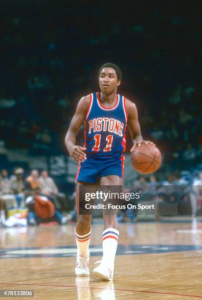 Isiah Thomas of the Detroit Pistons dribbles the ball up court against the Washington Bullets during an NBA basketball game circa 1982 at The Capital...