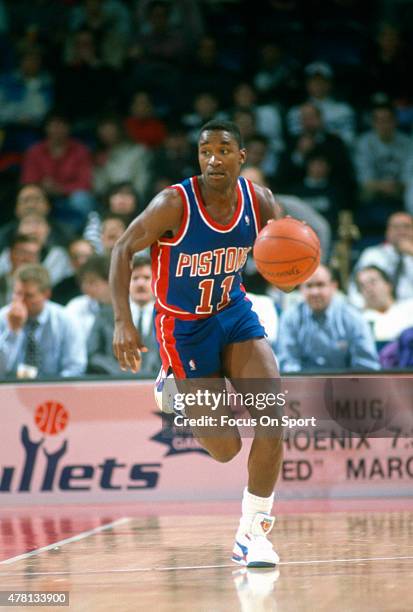 Isiah Thomas of the Detroit Pistons dribbles the ball up court against the Washington Bullets during an NBA basketball game circa 1990 at The Capital...