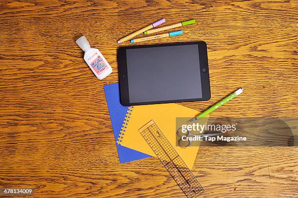 An Apple iPad Mini laid out alongside a selection of art and craft materials, photographed for a feature on tablet devices and creativity, taken on...
