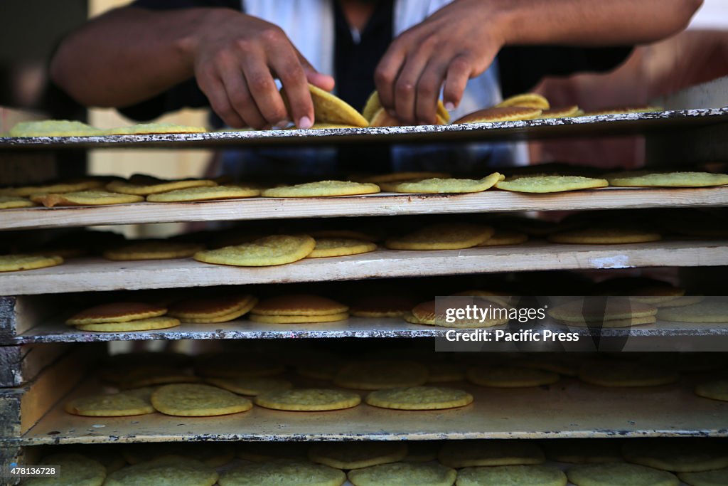 A Palestinian vendor prepares traditional pancakes known as...