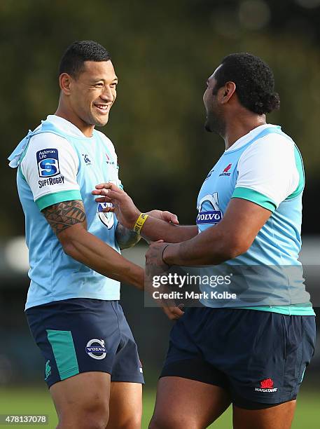 Israel Folau shares a joke with Taqele Naiyaravoro during a Waratahs Super Rugby training session at Moore Park on June 23, 2015 in Sydney, Australia.