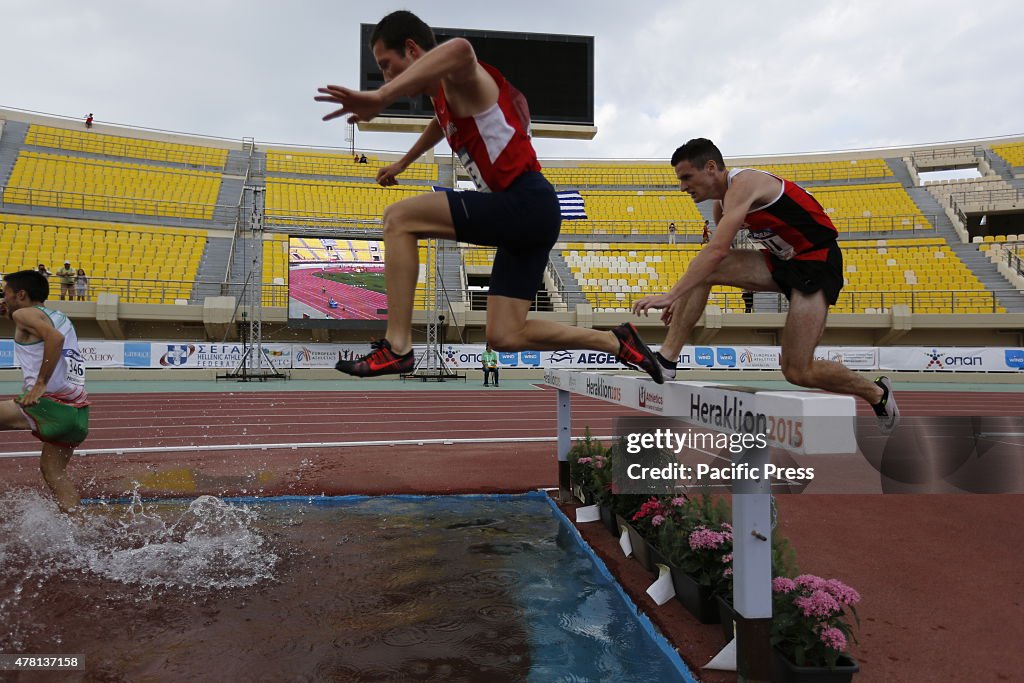 3000 metres steeplechase runners jump over the water jump at...