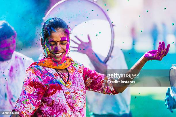 celebrating the holi festival of colors - rajasthani women stock pictures, royalty-free photos & images
