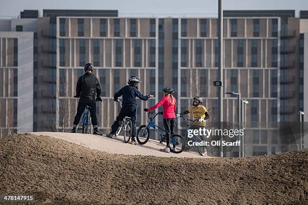 Cyclists ride the BMX track at the Lee Valley Velopark, formerly the cycling venue for the London 2012 Olympic Games, on March 12, 2014 in London,...