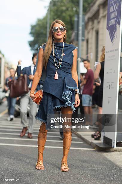 Anna Dello Russo enters the Prada show in a Marques Almeida denim dress, Valentino sandals, and hair by Satoshi Klein on June 21, 2015 in Milan,...