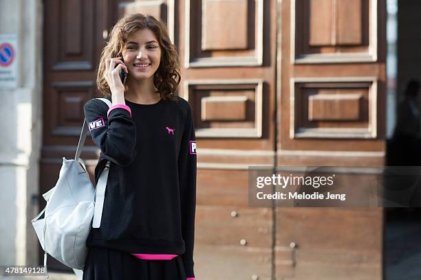 Valery Kaufman exits the Prada show in a VS Pink top poses on June 21, 2015 in Milan, Italy.