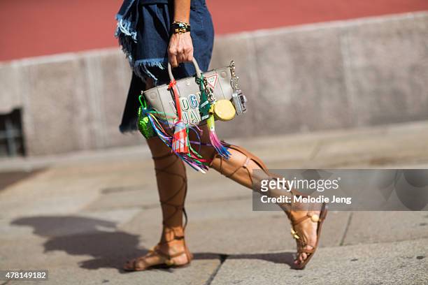 Anna Dello Russo carries an Anya Hindmarch bag with a Marques Almeida dress and Valentino shoes poses on June 21, 2015 in Milan, Italy.