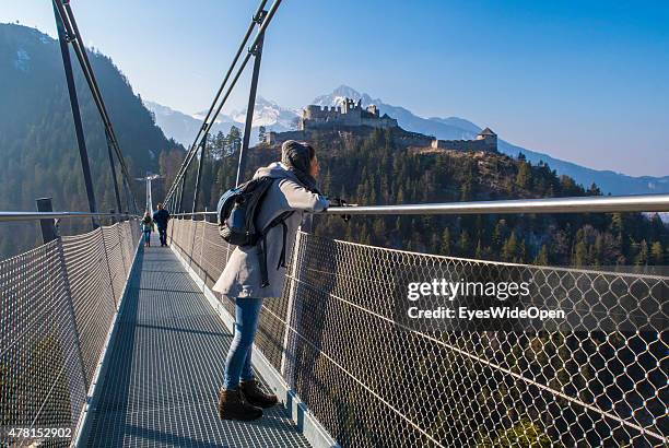 Tourists and hiker visit the sightseeing point of Castle Ehrenberg which has the longest Tibet-style suspension bridge in the world , on March 20,...