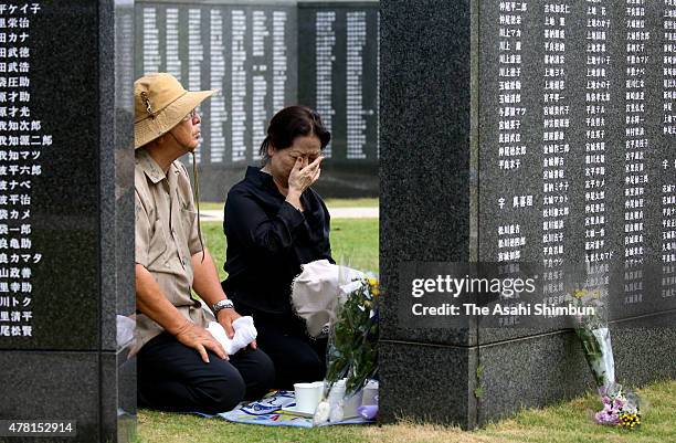 Woman sheds tears for the victims in front of the Cornerstone of Peace memorial at the 'Mabuni-no-oka', in Peace Memorial Park as Japan marks the...