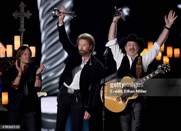 Recording artist Keith Urban presents honorees Ronnie Dunn and Kix Brooks of Brooks & Dunn with the 50th Anniversary Milestone Award for Most Awarded...