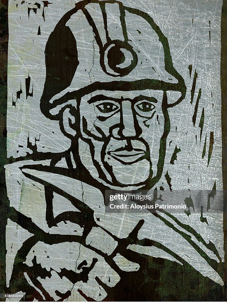 A coal miner holding a pick axe