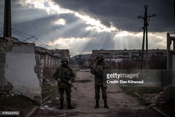 Armed men believed to be Russian military stand outside a Ukrainian military base on March 12, 2014 in Simferopol, Ukraine. As the standoff between...