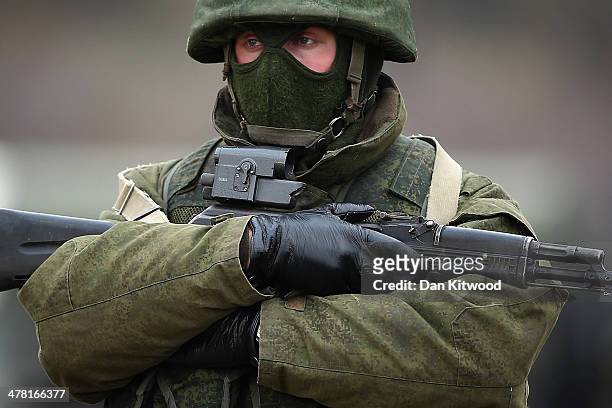 Armed men believed to be Russian military patrol outside a Ukrainian military base on March 12, 2014 in Simferopol, Ukraine. As the standoff between...