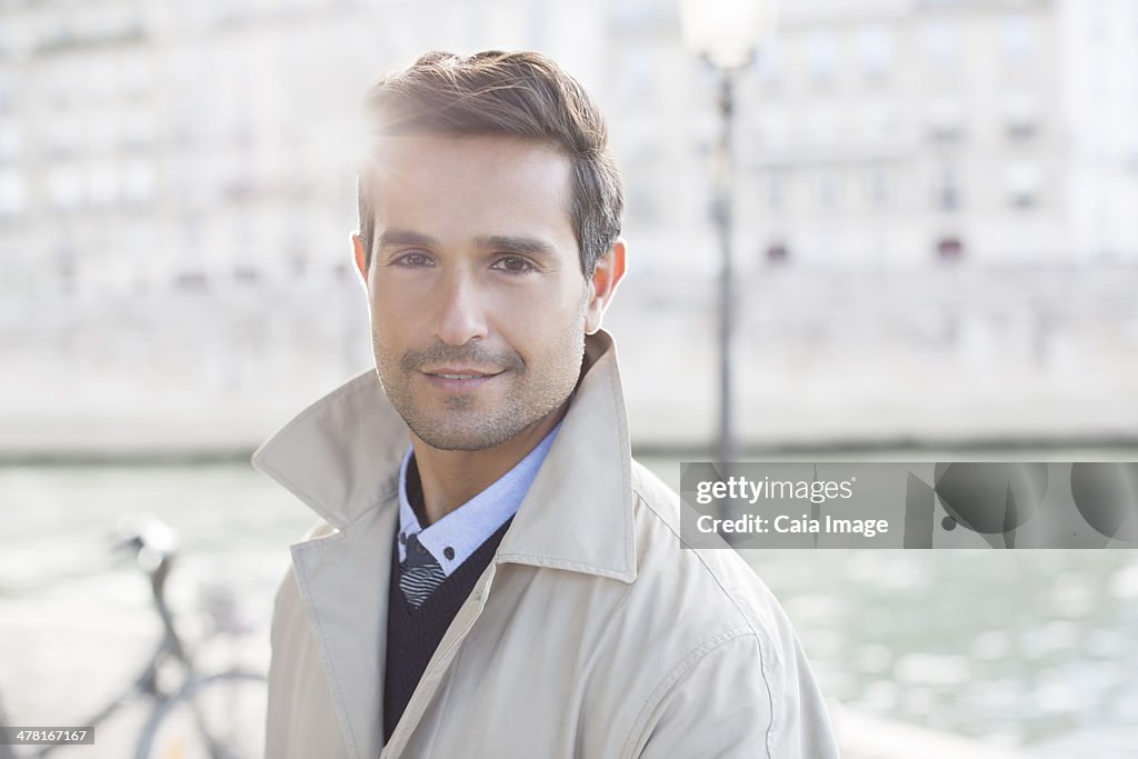 Businessman smiling along Seine River, Paris, France