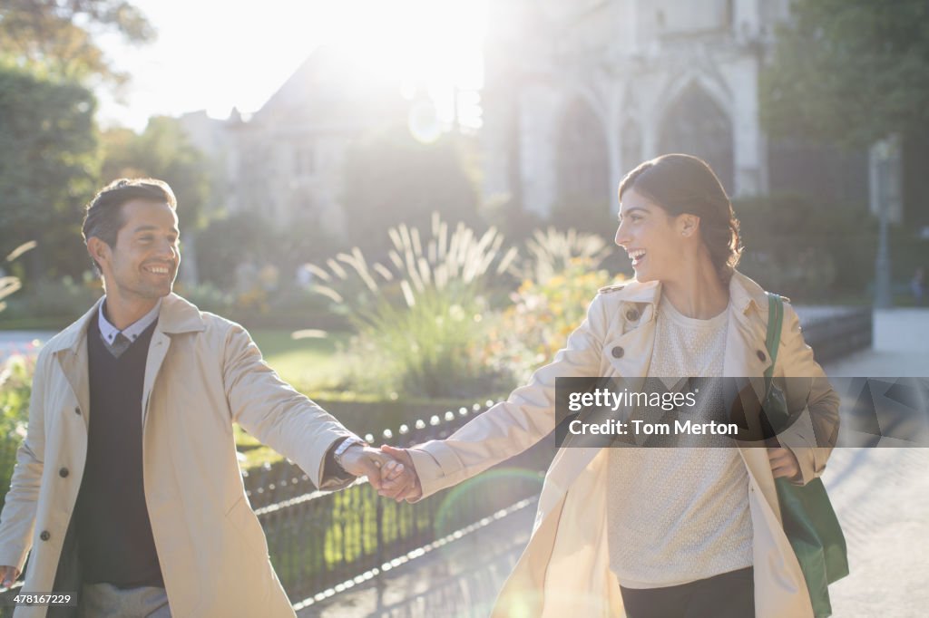 Couple holding hands in urban park