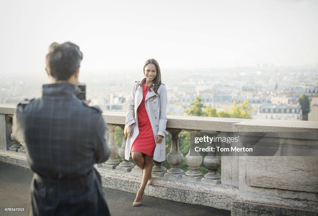 Boyfriend photographing girlfriend with Paris in background