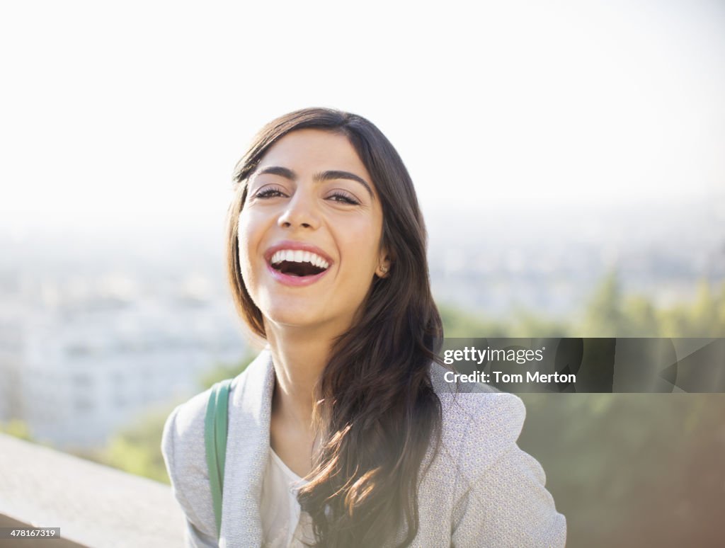 Woman laughing outdoors