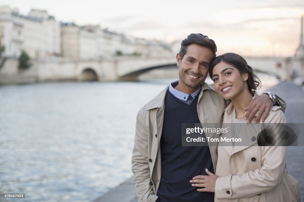 Couple walking along Seine River, Paris, France