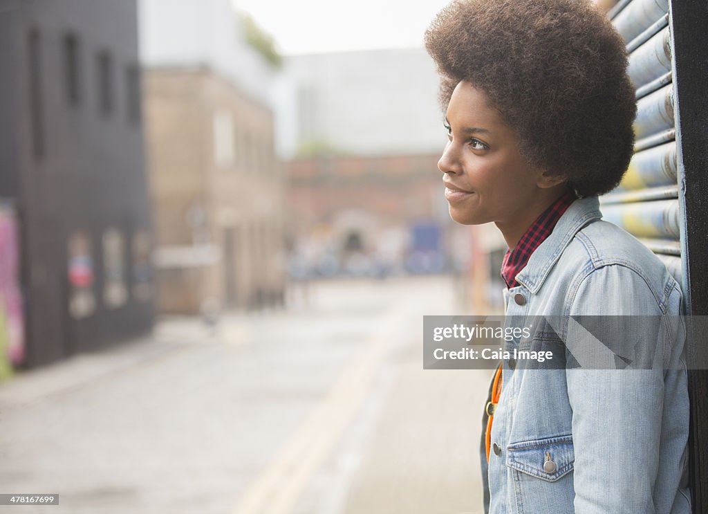 Pensive woman standing on city street