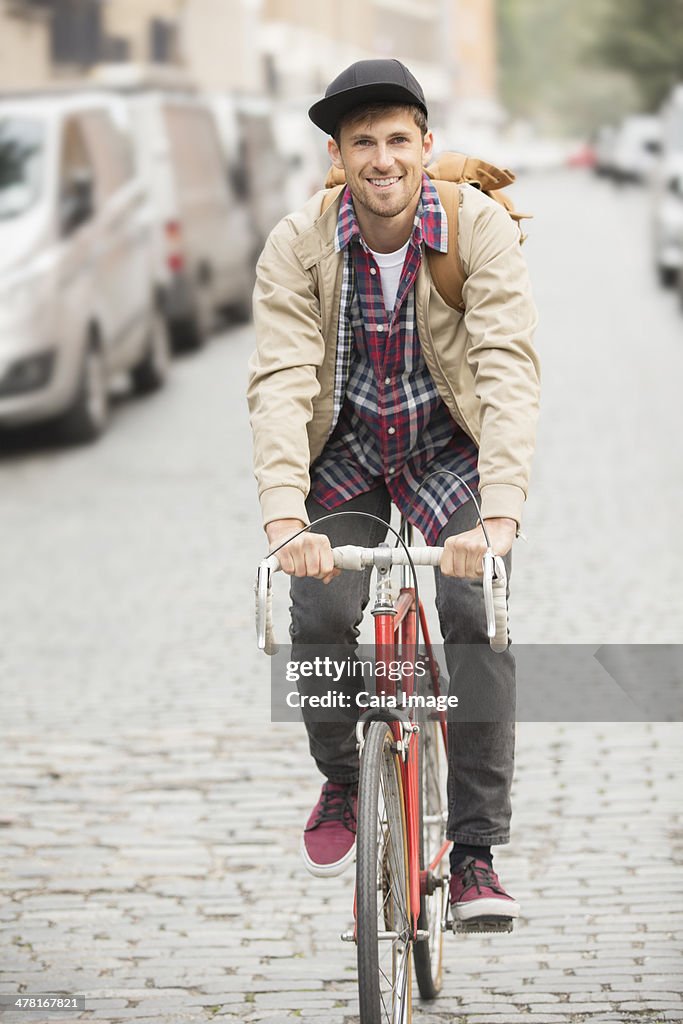 Man riding bicycle on city street