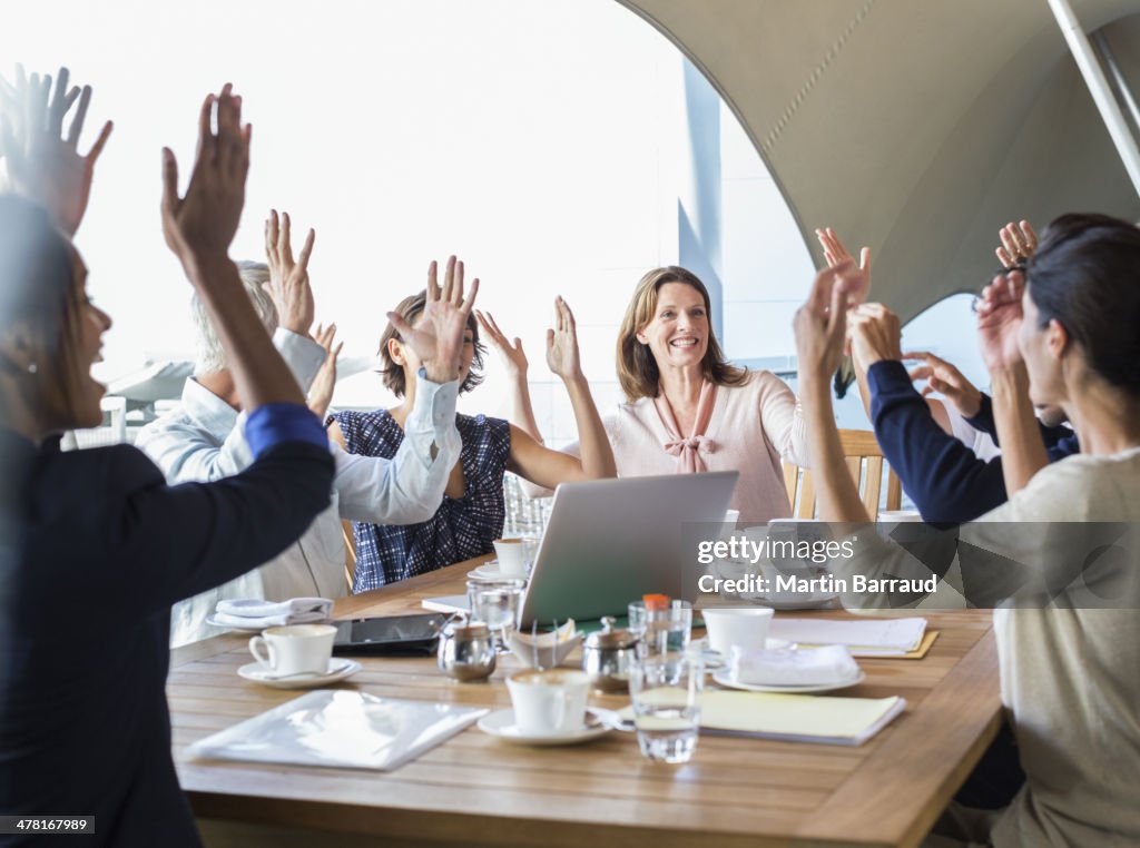 Business people cheering in meeting