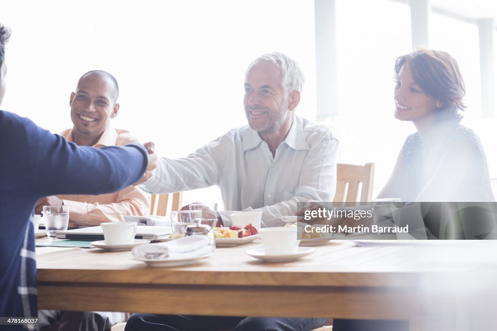 Business people shaking hands in meeting