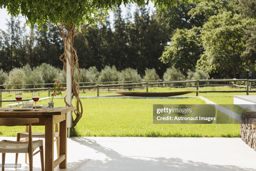 Dining table and chairs on patio overlooking backyard