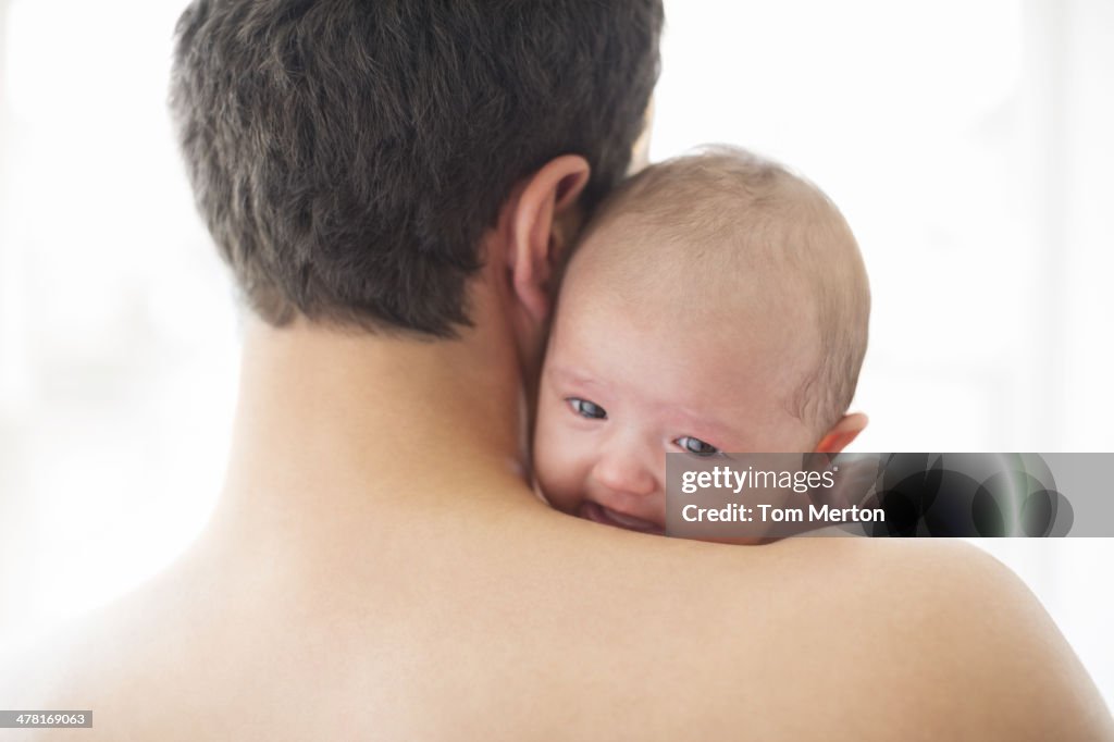 Man comforting crying baby girl