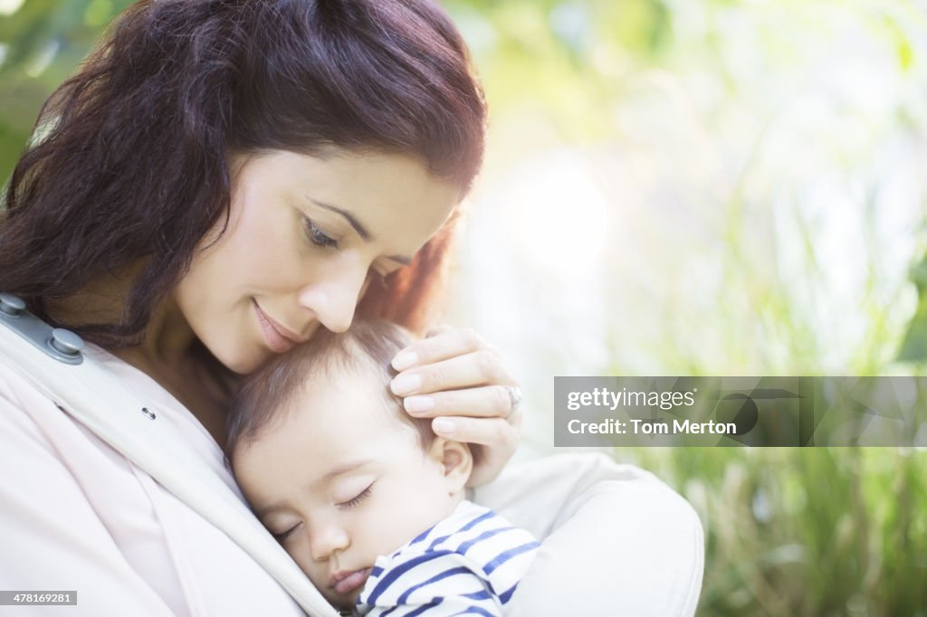 Mother holding sleeping baby girl