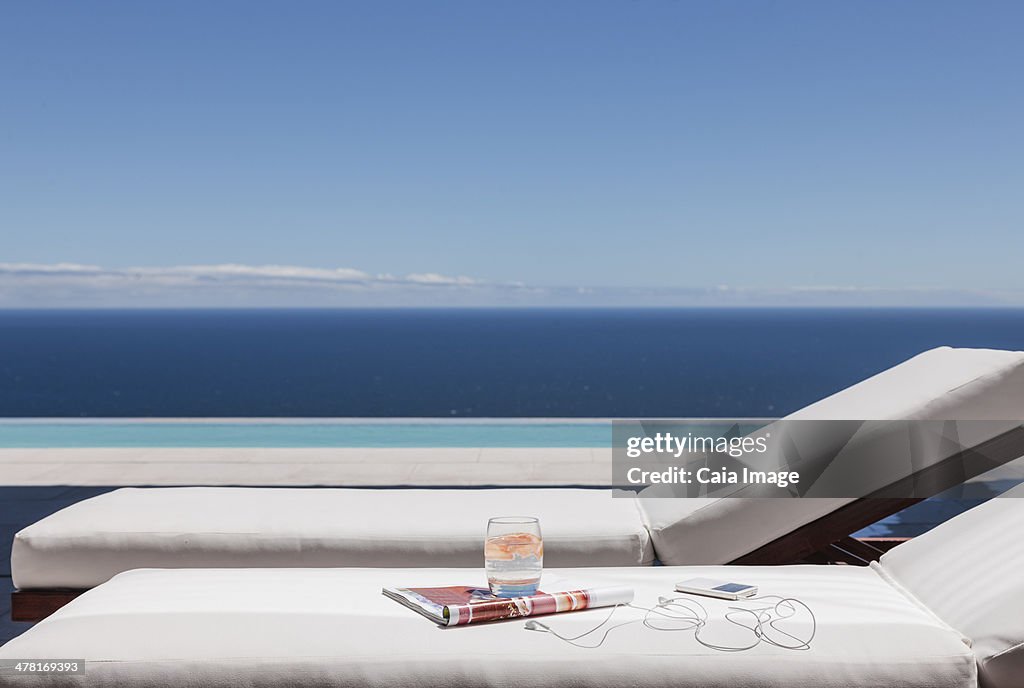 Lounge chairs on balcony overlooking ocean