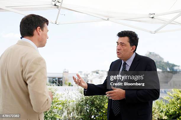 Alexis Papahelas, chief editor of Kathimerini newspaper, right, speaks to Guy Johnson, Bloomberg Television anchor, during a Bloomberg Television...