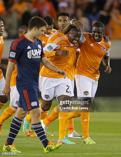 Boniek Garcia of Houston Dynamo is congratulated by Will Bruin and Giles Barnes after scoring against the New England Revolution at BBVA Compass...