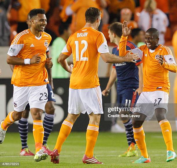 Boniek Garcia of Houston Dynamo is congratulated by Will Bruin and Giles Barnes after scoring against the New England Revolution at BBVA Compass...