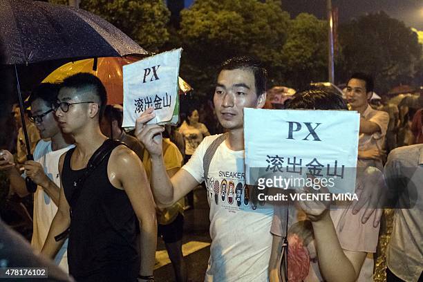 Demonstrators hold banners with slogans to protest against a paraxylene project in Jinshan district in Shanghai on June 23, 2015. Several hundreds of...