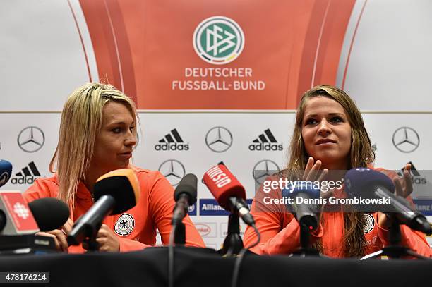 Lena Goessling and Melanie Leupolz of Germany face the media during a press conference at Montreal Convention Centre on June 23, 2015 in Montreal,...