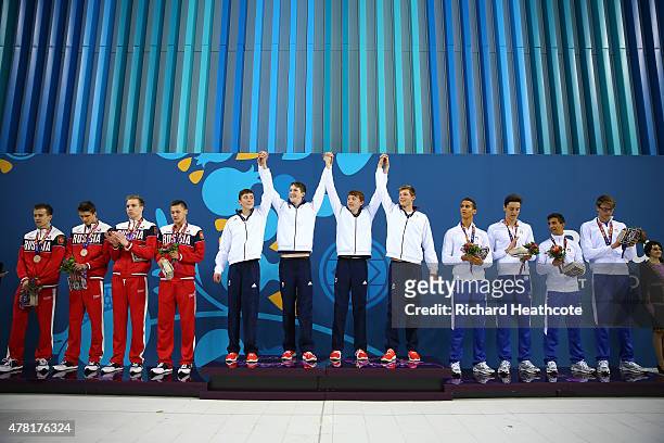 Bronze medalists Russia, Gold medalists Great Britain and silver medalists Italy celebrate on the medal podium for the Men's 4 x 100m Freestyle Relay...