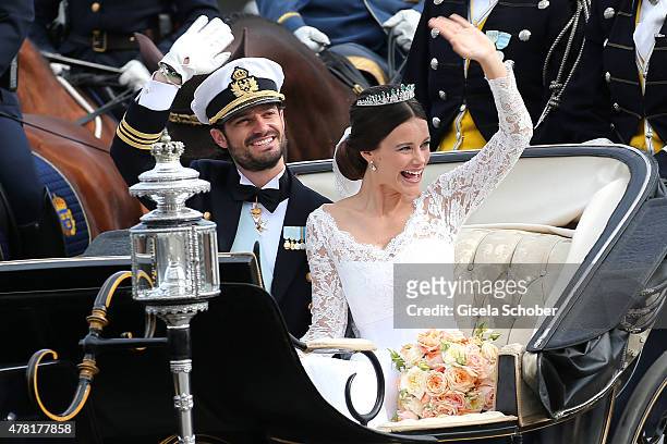 Prince Carl Philip of Sweden and his wife Princess Sofia of Sweden ride in the wedding cortege after their marriage ceremony on June 13, 2015 in...