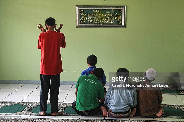 Blind people praying at a blind foundation on June 23, 2015 in Tangerang, Indonesia. During the month of ramadan they learn to read Braille Quran.....