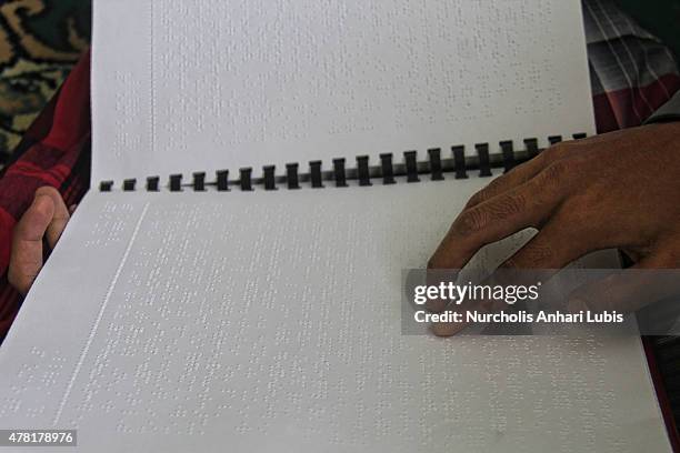 Blind reads a Braille Quran at a blind foundation on June 23, 2015 in Tangerang, Indonesia. Braille Quran is the translation of Quran verses to...