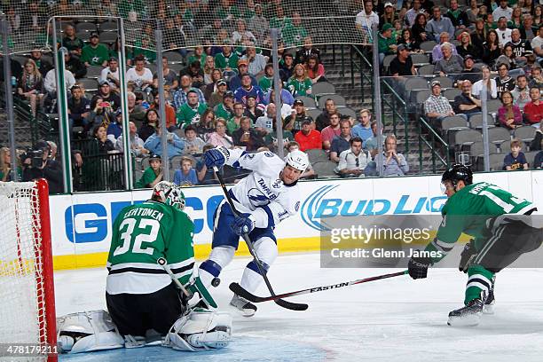 Ryan Malone of the Tampa Bay Lightning tries to bang home a shot from point blank range against Kari Lehtonen and Ray Whitney of the Dallas Stars at...